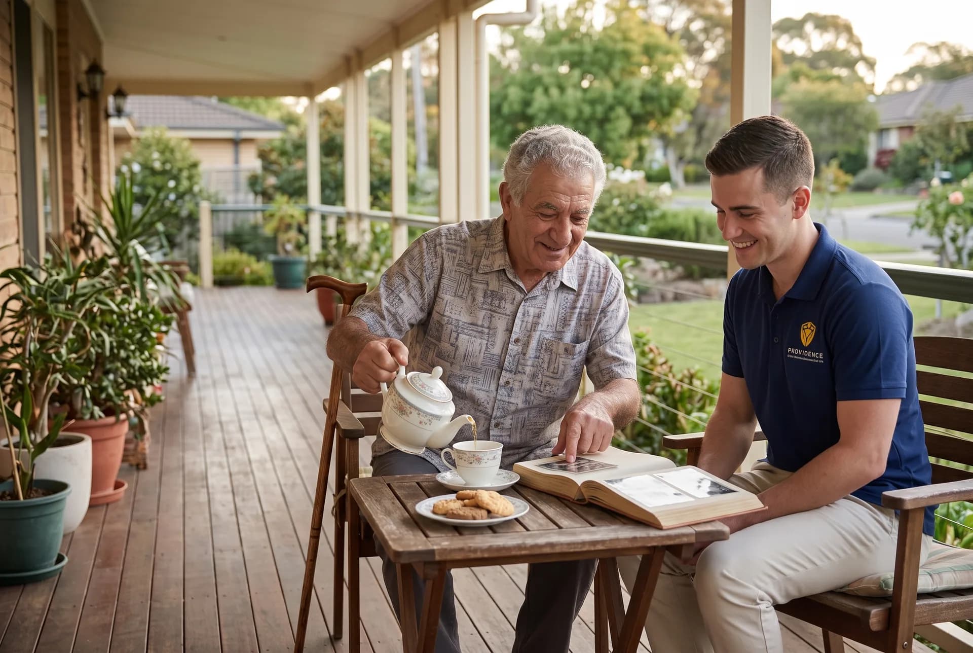 Providence support worker sharing tea and conversation with an older participant on his front porch